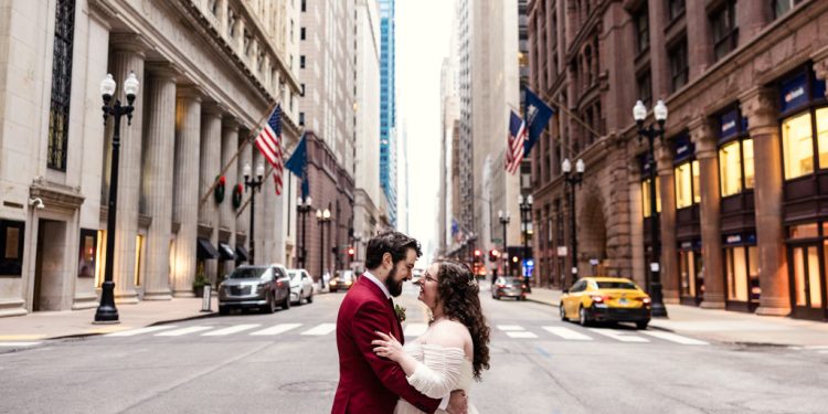 Romantic photo of bride and groom in LaSalle street downtown Chicago before their winter City View Loft wedding
