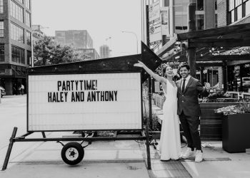 Black and white photo of couple in front of custom marquee before summer Morgan's on Fulton wedding reception