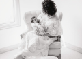 Feeding your baby, mother holds her newborn in a comfortable chair by the window