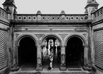Romantic black and white engagement photo of couple at Bethesda Terrace in Central Park, NYC