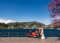 Romantic photo of bride and groom with red Vespa after their destination Lake Como elopement in Italy