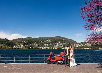 Romantic photo of bride and groom with red Vespa after their destination Lake Como elopement in Italy